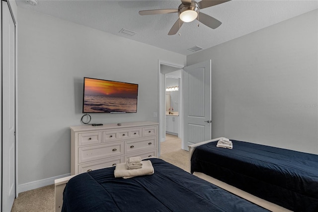 bedroom featuring ceiling fan, a textured ceiling, and light colored carpet