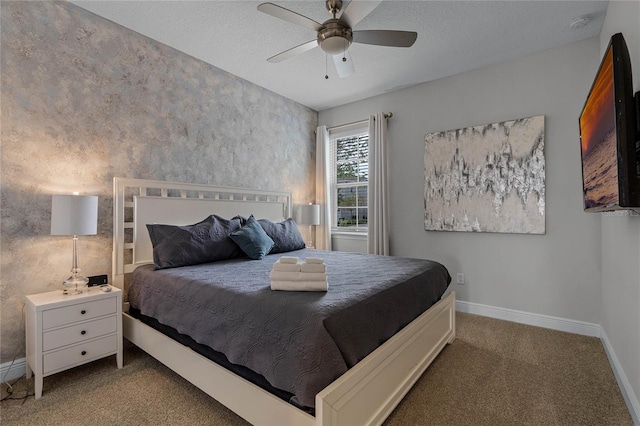 carpeted bedroom featuring ceiling fan and a textured ceiling