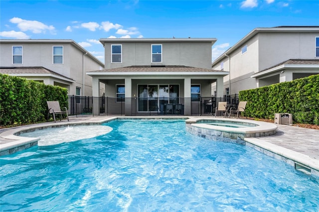 view of swimming pool featuring an in ground hot tub