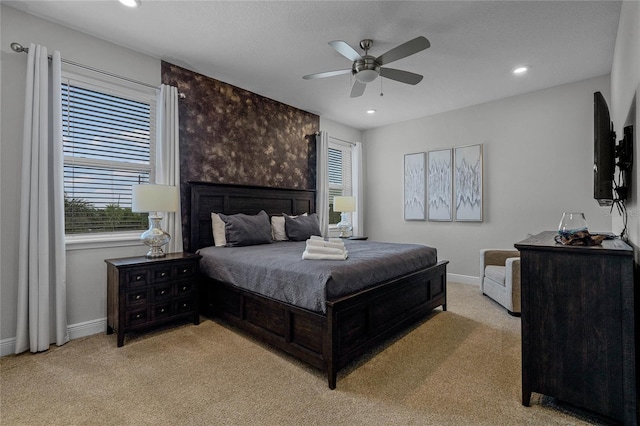 bedroom with light colored carpet and ceiling fan