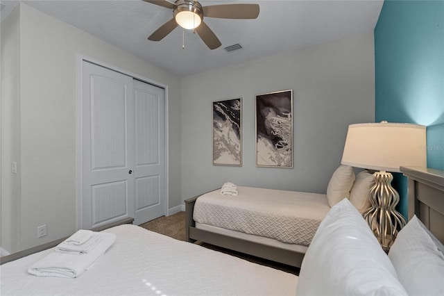 carpeted bedroom featuring a closet and ceiling fan