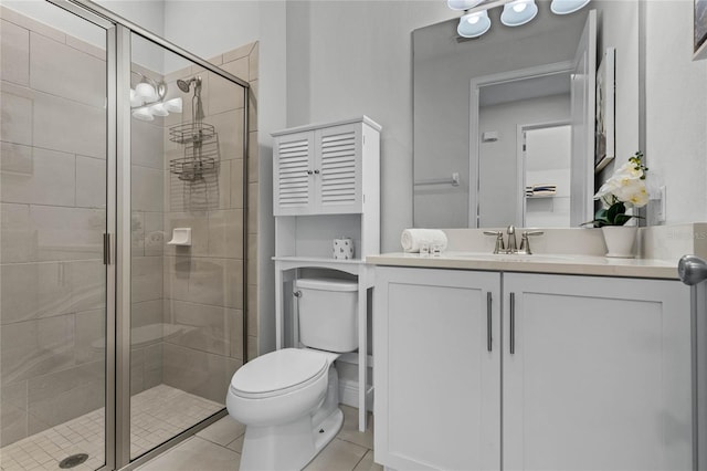 bathroom featuring vanity, a shower with shower door, toilet, and tile patterned floors