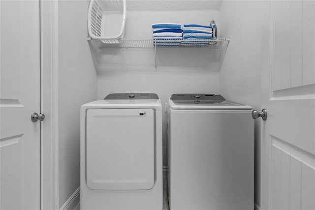 laundry room featuring washer and dryer and a textured ceiling