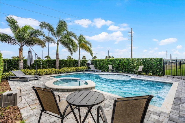 view of pool featuring an in ground hot tub and a patio area