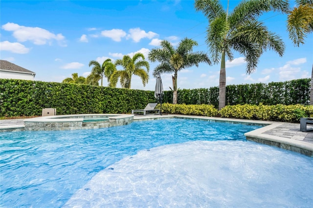 view of swimming pool with an in ground hot tub