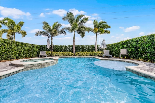 view of pool featuring an in ground hot tub