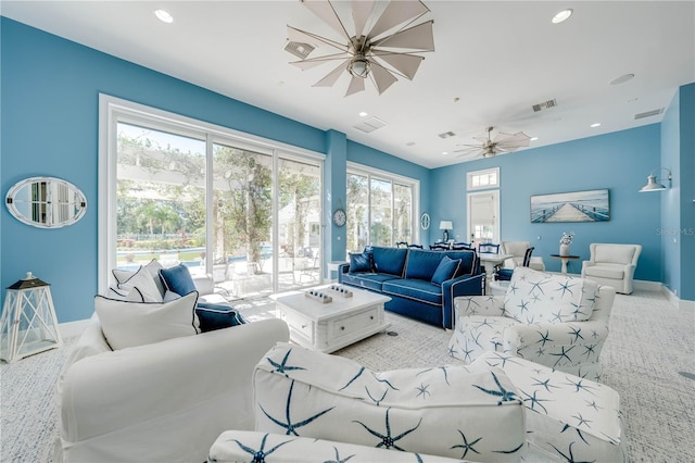 carpeted living room featuring ceiling fan