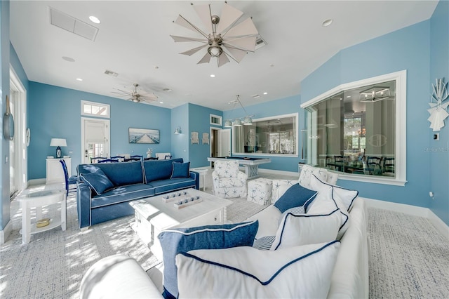 carpeted living room featuring ceiling fan