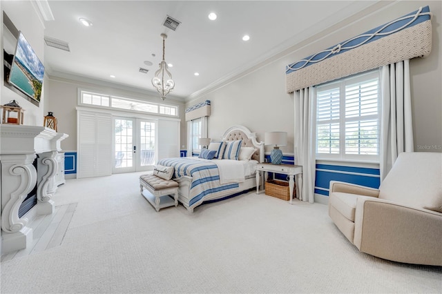 bedroom with french doors, light carpet, crown molding, and an inviting chandelier