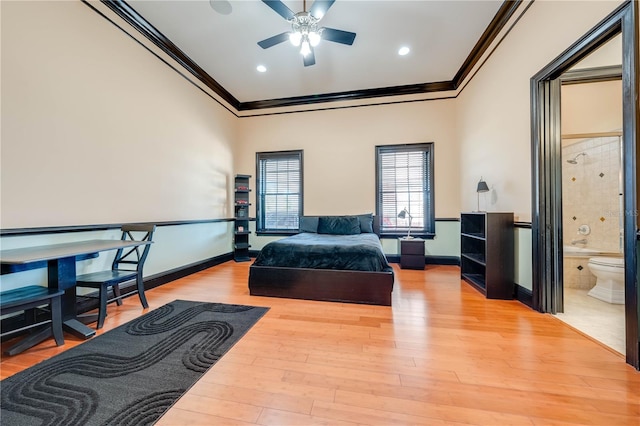 bedroom featuring ornamental molding, wood-type flooring, ceiling fan, and ensuite bath