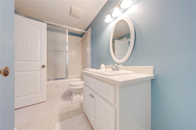 full bathroom featuring toilet, vanity, bath / shower combo with glass door, and tile patterned floors