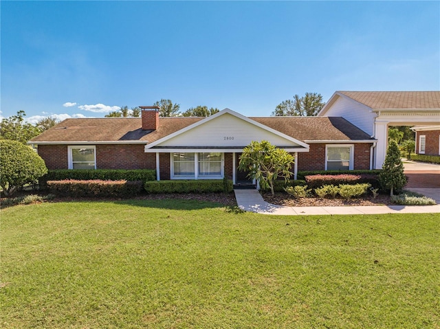 single story home featuring a front lawn