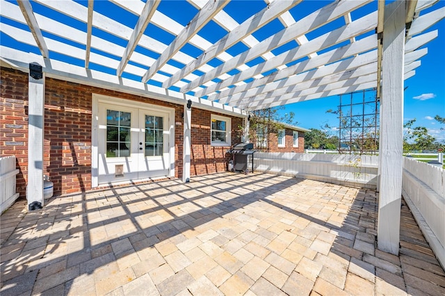 view of patio featuring french doors, area for grilling, and a pergola