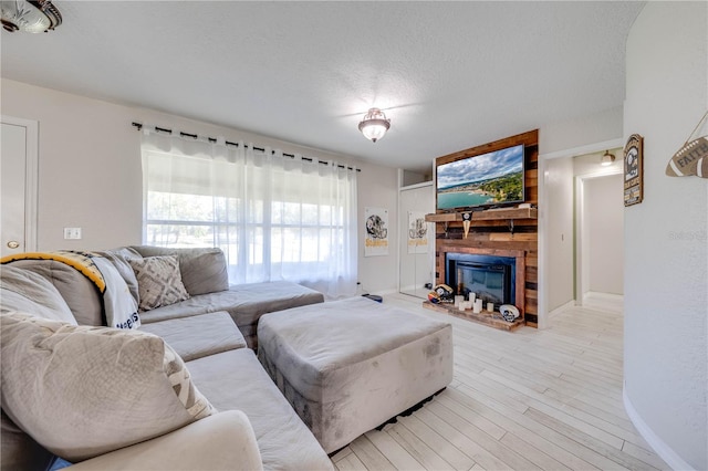 living room with light hardwood / wood-style floors and a textured ceiling