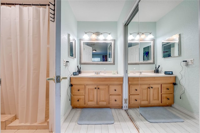 bathroom with vanity, hardwood / wood-style flooring, and curtained shower