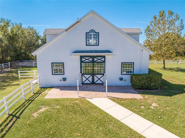 view of front facade with a front yard and a patio area