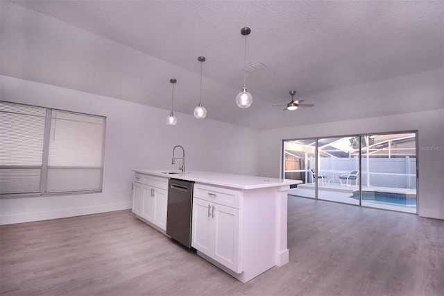 kitchen with hanging light fixtures, white cabinetry, light wood-type flooring, dishwasher, and sink