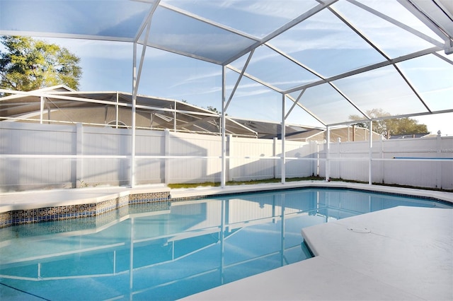 view of pool featuring glass enclosure