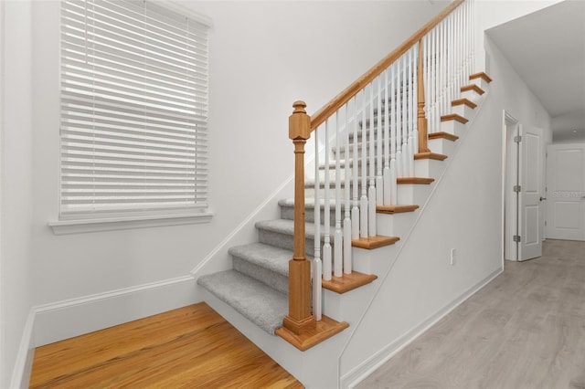 stairs featuring wood-type flooring