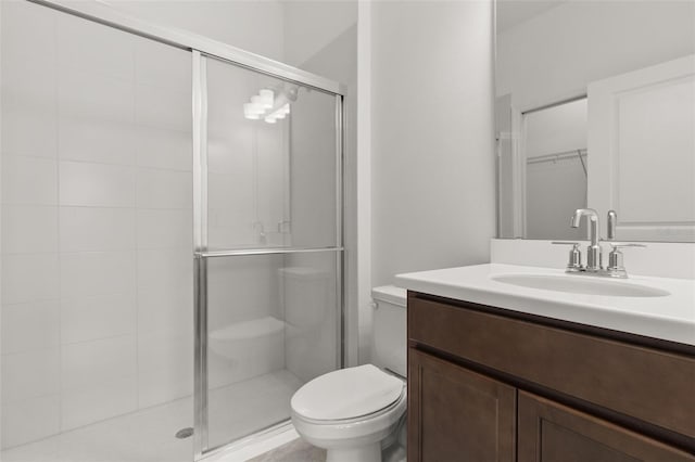 bathroom with vanity, toilet, and walk in shower