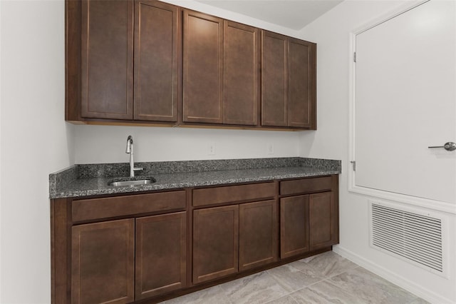 kitchen with dark brown cabinetry and sink