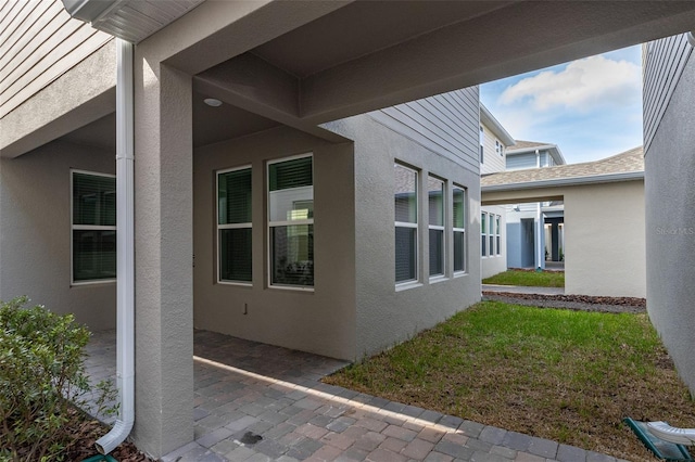 view of side of home with a lawn