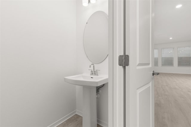 bathroom with hardwood / wood-style flooring