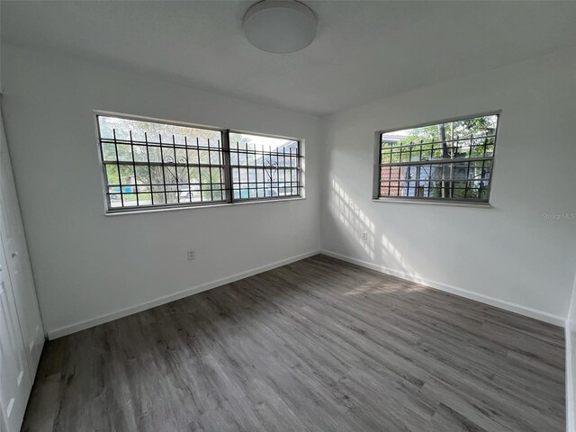 empty room featuring dark hardwood / wood-style flooring