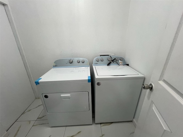 washroom with independent washer and dryer