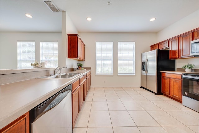 kitchen with stainless steel appliances, visible vents, a healthy amount of sunlight, and a sink