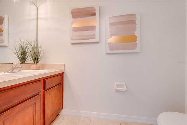 bathroom featuring baseboards, toilet, vanity, and tile patterned flooring