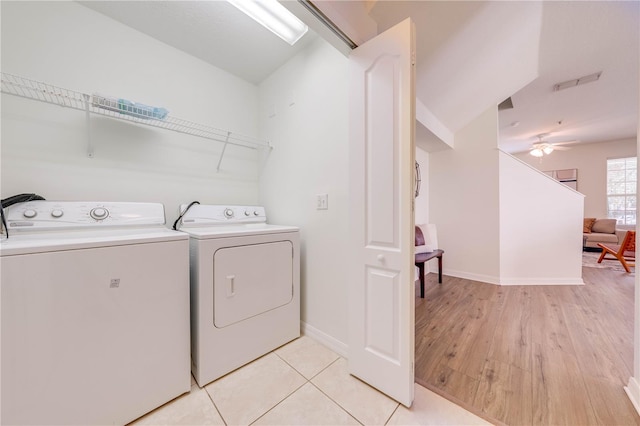 laundry area featuring visible vents, light wood-style flooring, a ceiling fan, washer and dryer, and laundry area