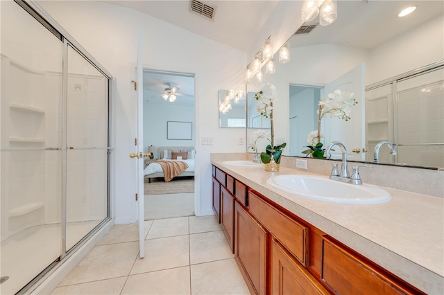 bathroom featuring vanity, vaulted ceiling, tile patterned flooring, ceiling fan, and a shower with shower door