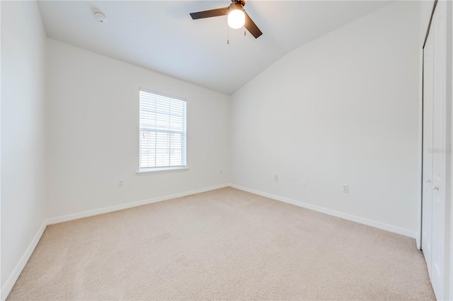unfurnished room featuring a ceiling fan, baseboards, light colored carpet, and lofted ceiling