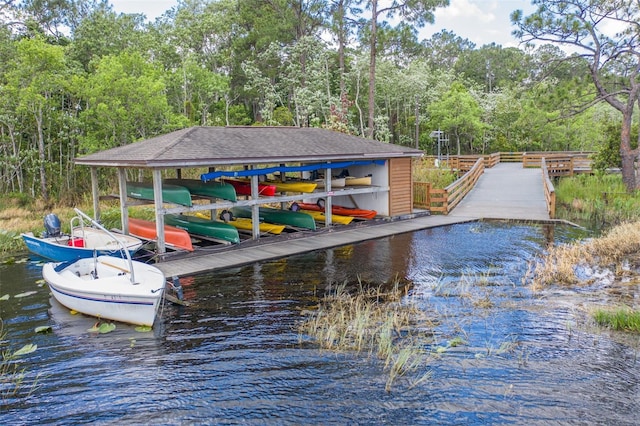 dock area with a water view and a view of trees