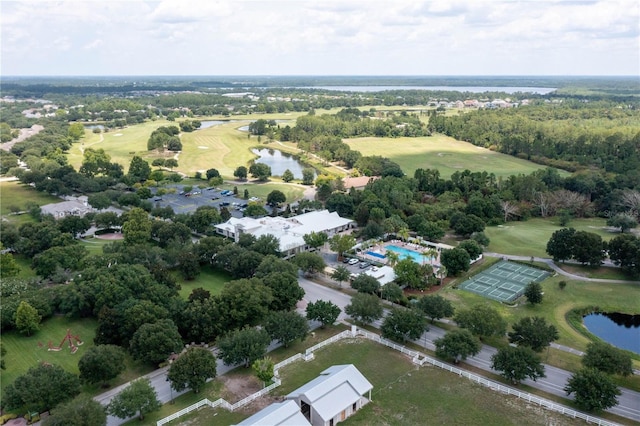 drone / aerial view with a water view and golf course view