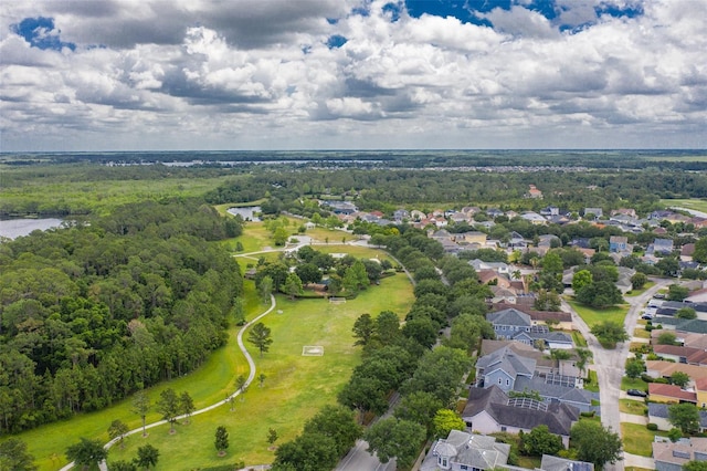 drone / aerial view with a forest view, a residential view, and a water view