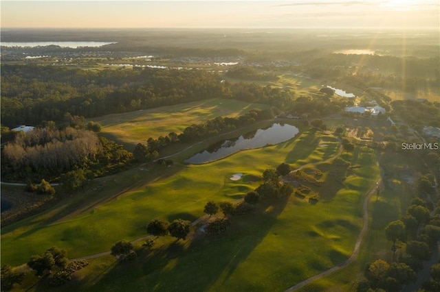 aerial view at dusk featuring a water view