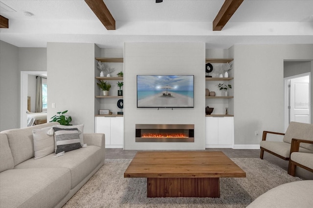 living room featuring beamed ceiling and a textured ceiling