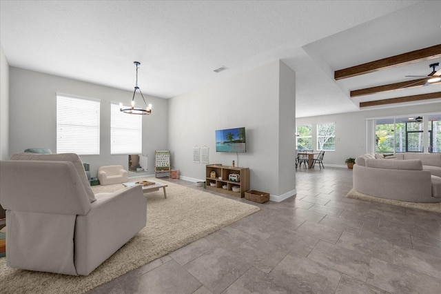 tiled living room with beam ceiling and ceiling fan with notable chandelier