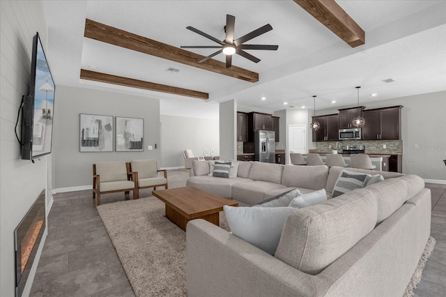 living room with beam ceiling and ceiling fan