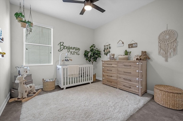 bedroom featuring a crib and ceiling fan