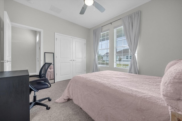 carpeted bedroom with a closet and ceiling fan