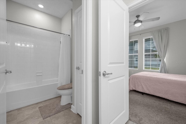 bathroom featuring toilet, tile patterned floors, shower / bath combo with shower curtain, and ceiling fan