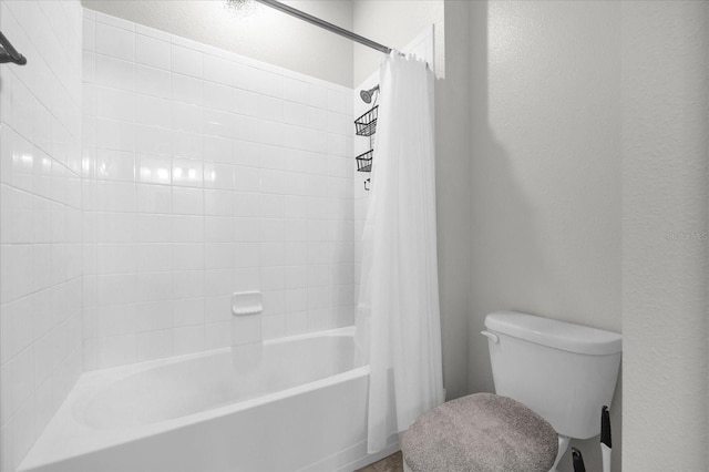 bathroom featuring toilet and shower / bath combination with curtain