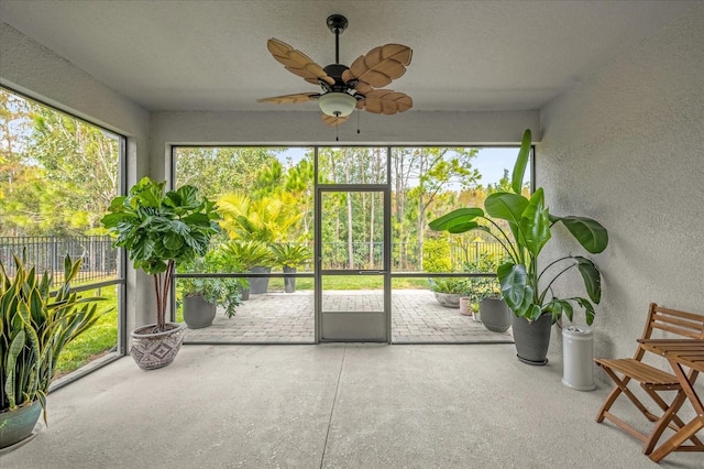 unfurnished sunroom featuring ceiling fan