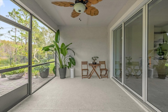 sunroom featuring ceiling fan