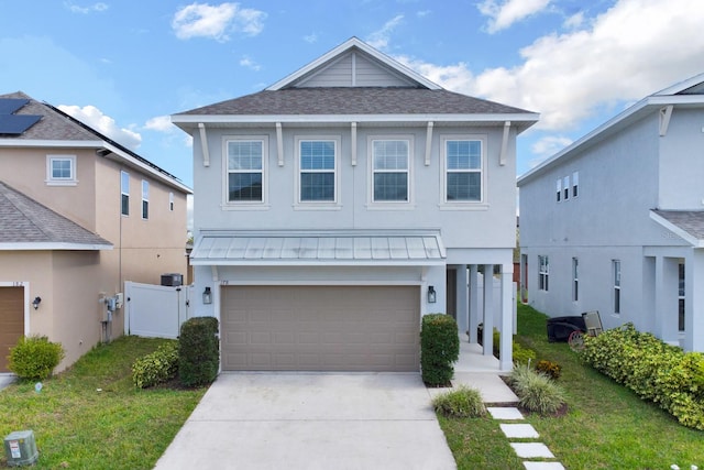 front facade with a front yard and a garage