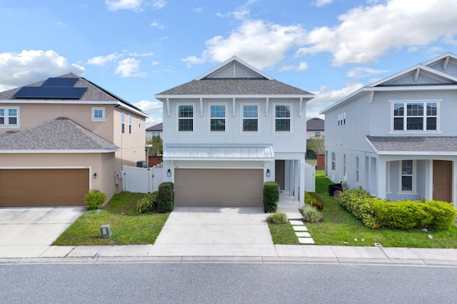 view of property featuring solar panels, a garage, and a front lawn