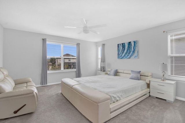 bedroom with light carpet and ceiling fan